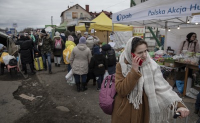 A Ukrainian refugee speaks on the phone after crossing the border in Dolhobyczow, Poland.